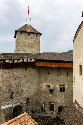 A vertical shot of beautiful courtyard of the ancient stone Chillon Castle, Veytaux, Switzerland