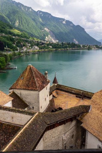 A vertical shot of an ancient Chillon Castle next to lake Geneva in Switzerland