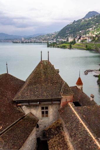 A vertical shot of an ancient Chillon Castle next to lake Geneva in Switzerland