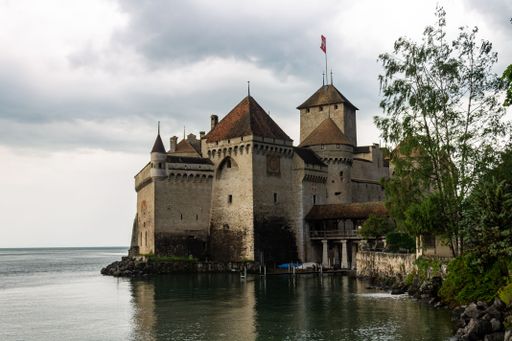 A beautiful shot of an ancient Chillon Castle next to a lake Geneva in Switzerland,