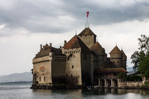A beautiful shot of an ancient Chillon Castle next to a lake Geneva in Switzerland,