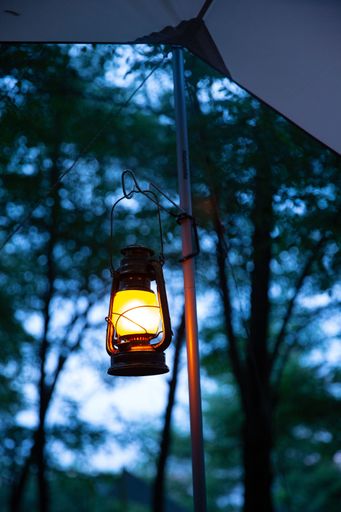 A vertical shot of a small lamp on the blurry background