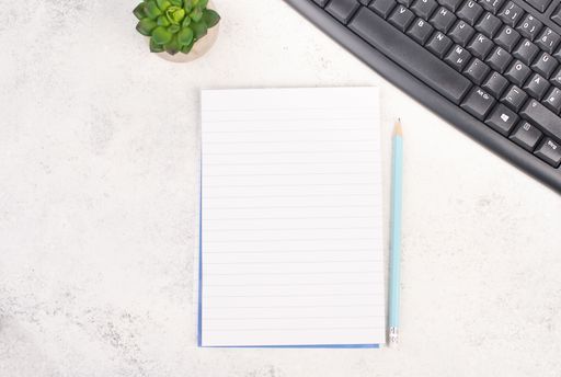 Empty paper with a pen, computer keyboard and a cactus, textured background, brainstorming for new ideas, writing a message, taking a break, home