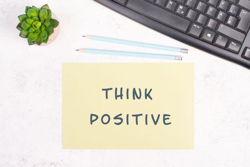 Think positive is standing on a paper, computer keyboard and a cactus, brainstorming for new ideas, new mindest, home office desk