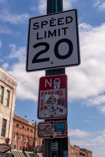 A vertical shot of a 20 speed limit sign on Beale Street in Memphis