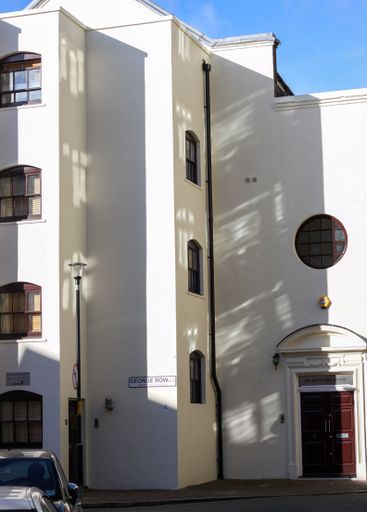 A vertical shot of a block of white residential buildings in London, UK
