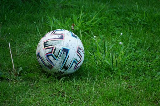 A closeup shot of a Football ball on a pitch, game concept