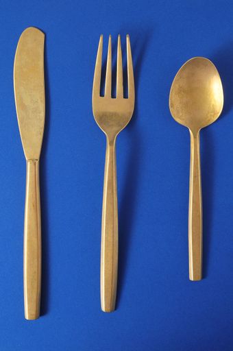 Ancient Vintage Silver Flatware on a Colored Background