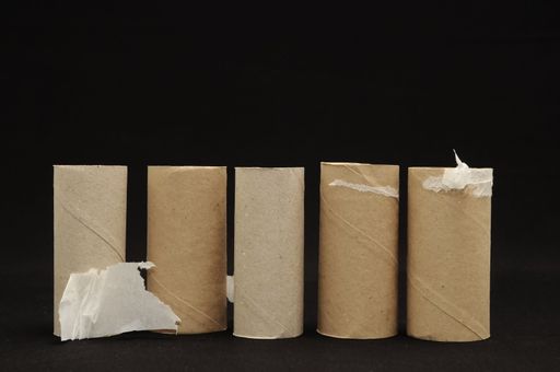Empty Toilet Rolls Stack Up On a Black Background