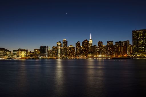 A beautiful view of the Manhattan skyscrapers in New York seen from Brooklyn at night