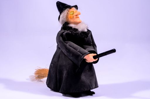 Clay Handmade Statue of a Witch on Black Background