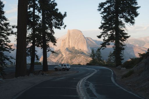 A car on an open road of the Yosemite National Park in California
