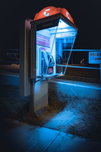 A vertical shot of a phone box at night in Narrabeen, northern Sydney