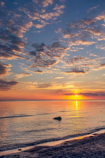 A vertical shot of a colorful sunset at the coast of the Baltic Sea, Lithuania
