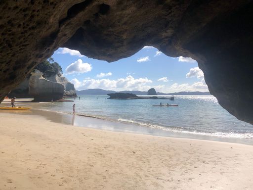A beautiful view of the Cathedral Cove, Marine Reserve by the sunny sea water in New Zealand