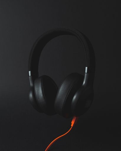 Wireless headphones with optional orange cord.