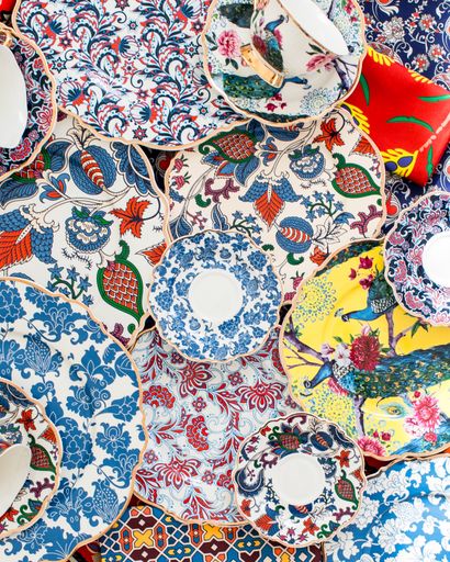 AN overhead shot of colorful decorative plates placed on top of each other