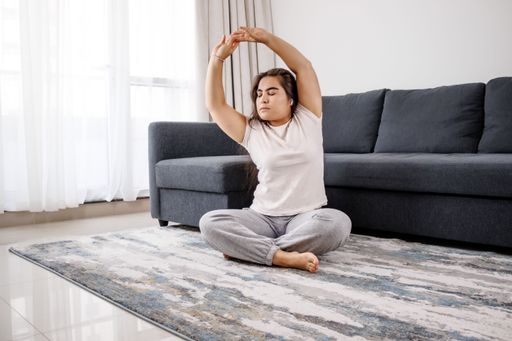 A caucasian girl does meditation, yoga, and self-cultivation in the house