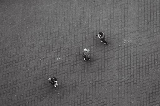 A top view of people standing on a pavement street in Hamburg, Germany