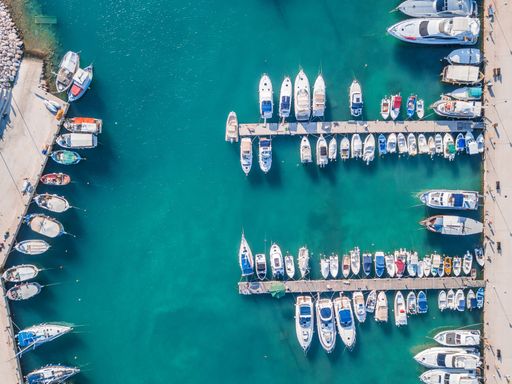 An aerial top-view of boats docked at the harbor in the sea in Greece