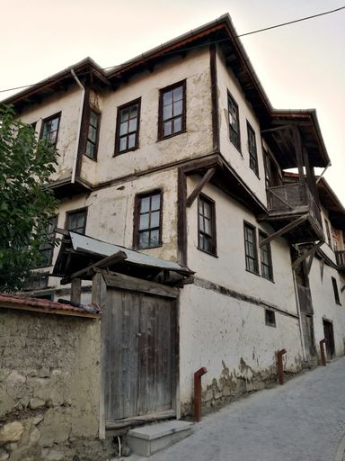 A low angle shot of a building in a worn out neighborhood