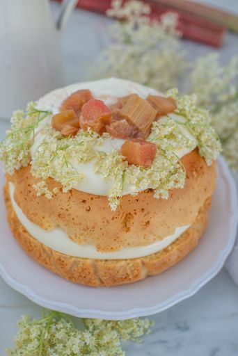 A closeup shot of a vanilla rhubarb cake with elderflower