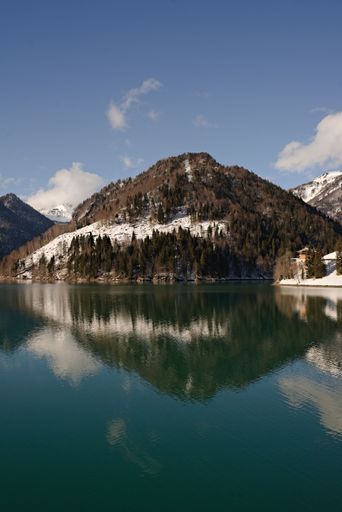 A vertical shot of a mountain in Carnic Alps range reflected in Sauris lake in Friuli-Venezia Giulia, Italy