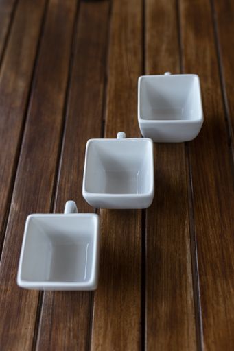 A vertical shot of an empty cups on a wooden table
