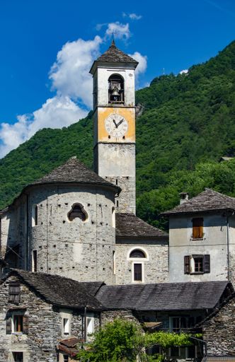 The parish church with trees surrounding it under a blue cloudy sky