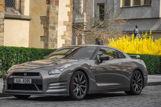 A gray Nissan GT-R parked on the side of a road