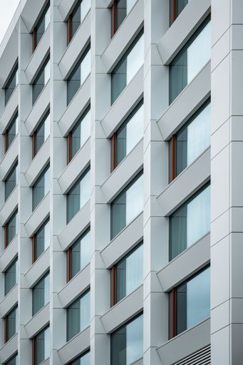 A vertical shot of a modern residential building block in an urban area