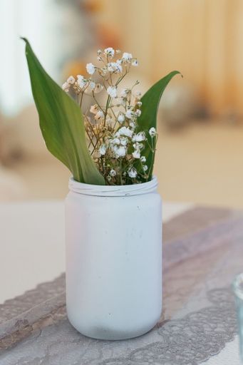 A vertical shot of gloveworts in the white vase on the blurry background