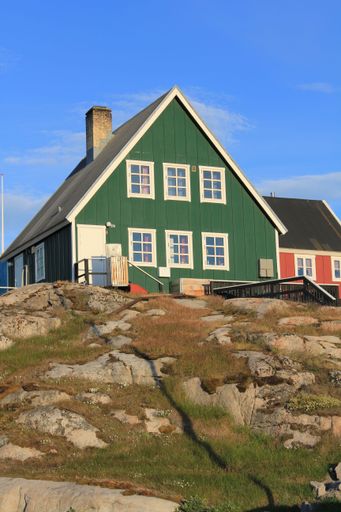 21 July 2011, Ilulissat, Greenland, Colourful houses in Arctic village at dusk (vertical)