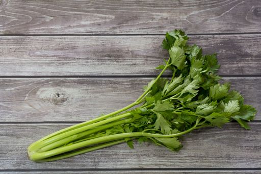 A closeup shot of fresh coriander on a wooden table