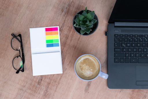 The office supplies on a desk with a cup of coffee to work from home because of Covid-19 pandemic