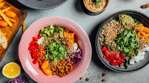 A top view of delicious vegan dishes on a gray table