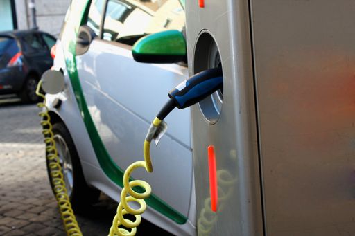 Charging an electric car with the power cable supply plugged in car.