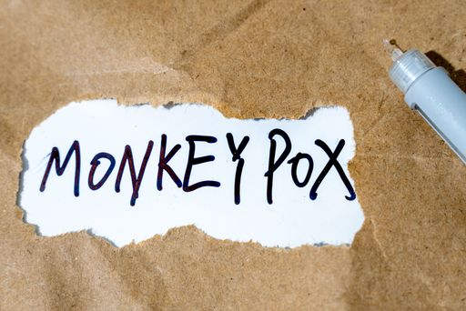 A closeup of a syringe next to a writing Monkeypox depicting the outbreak of the disease