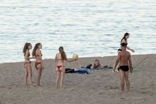 A young group of friends playing volleyball at the beach on daytime in Pals, Spain