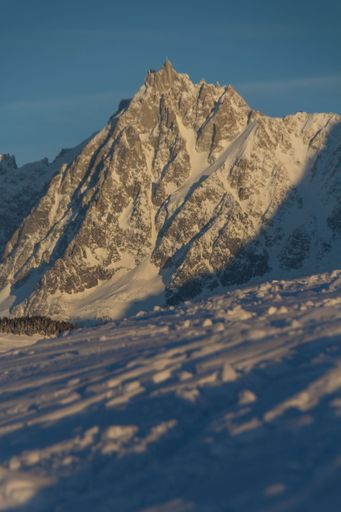 A vertical shot of the Aiguille du Midi mountain in the Mont Blanc massif within the French Alps
