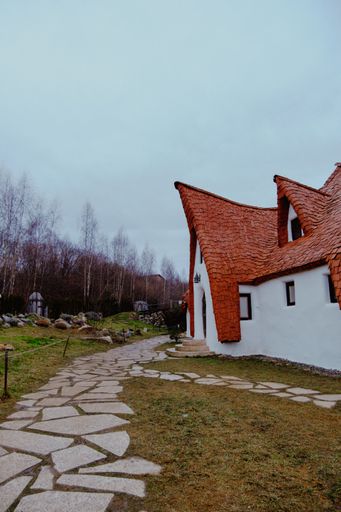A stone path leading to funny fairytale-style castle in the park