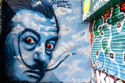 A closeup of graffiti portrait of Salvador Dali on a wall in Trafalgar Lane, Brighton, England