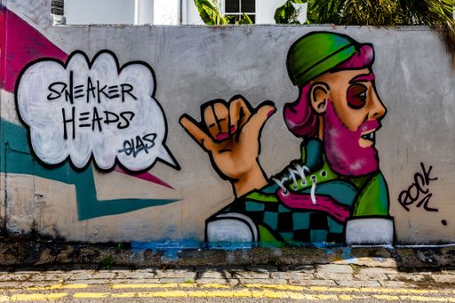A closeup of graffiti "sneaker heads" on a wall in Trafalgar Lane, Brighton, England