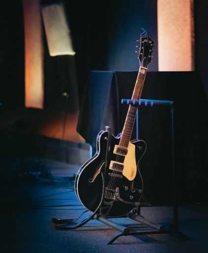 A vertical shot of an electric guitar on a stand