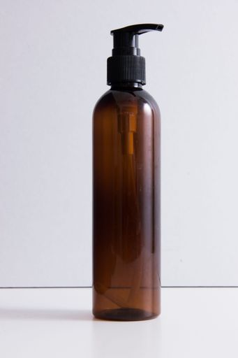A brown transparent bottle for shampoo isolated on white background