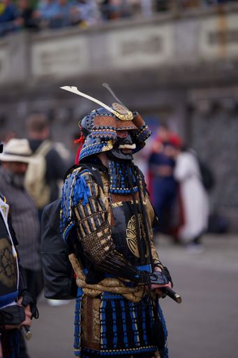 A vertical shot of a person dressed as a samurai during Japan Day celebrations