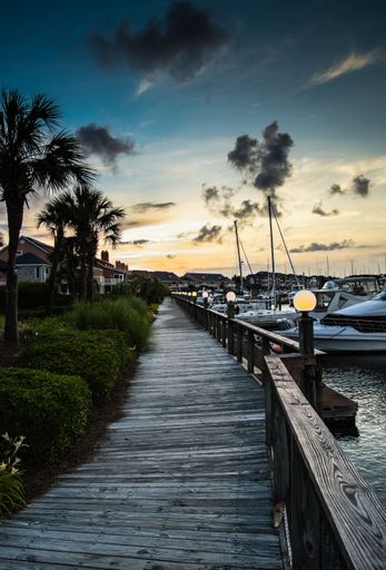 A beautiful vertical shot of a harbor during sunset