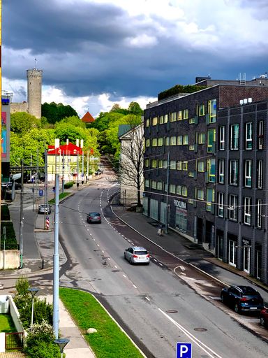 A vertical shot of a road with Tall Hermann tower in the background in Tallinn, Estonia