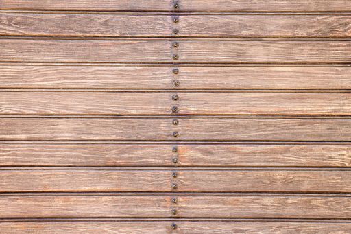 A background of brown wooden slats with screws in the center.
