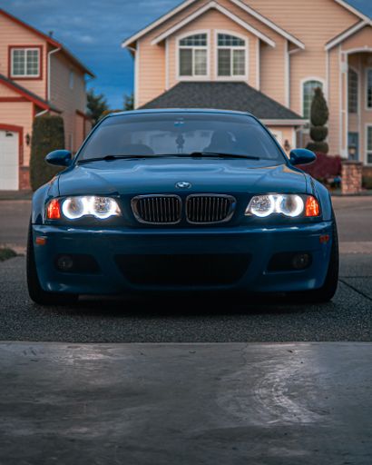 The BMW 2003 M3 Laguna Seca Blue parked in a yard